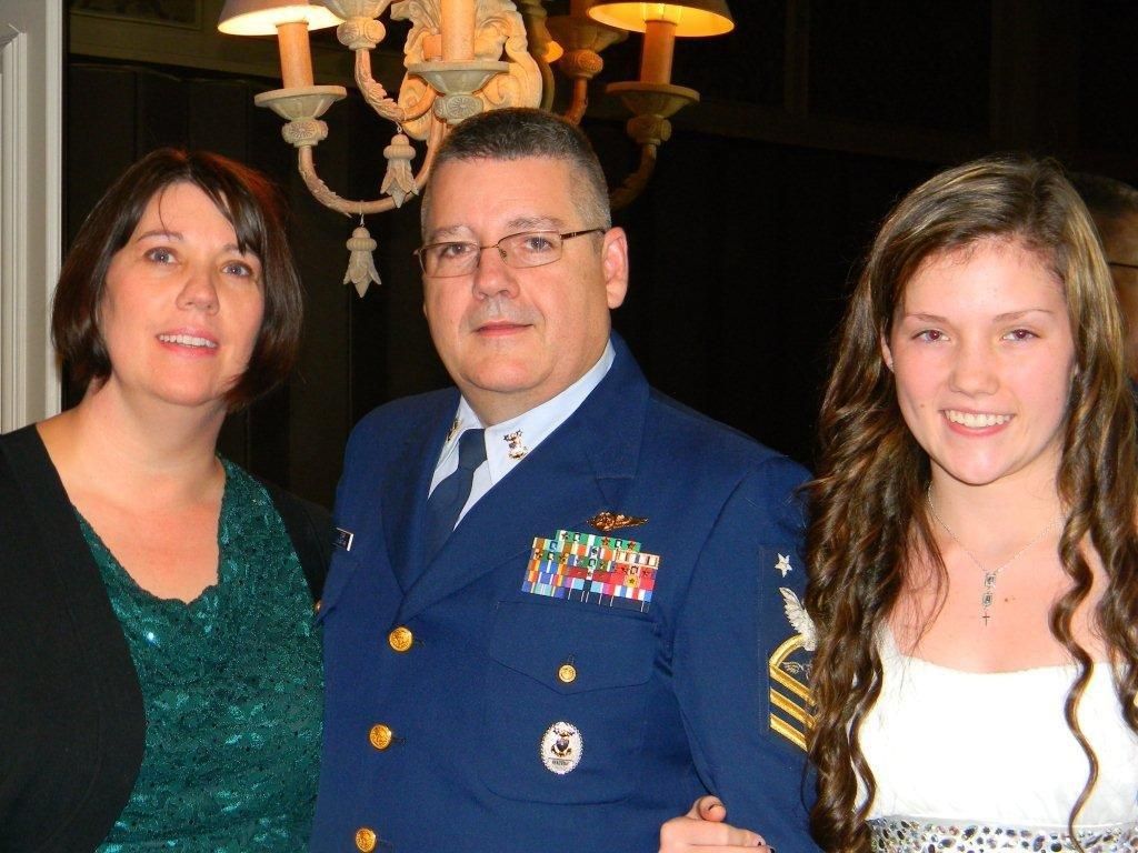 WIN Home Inspector in military uniform, holding his child.