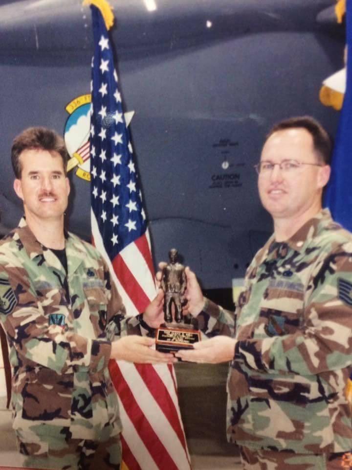 WIN Home Inspector in military uniform, holding his child.