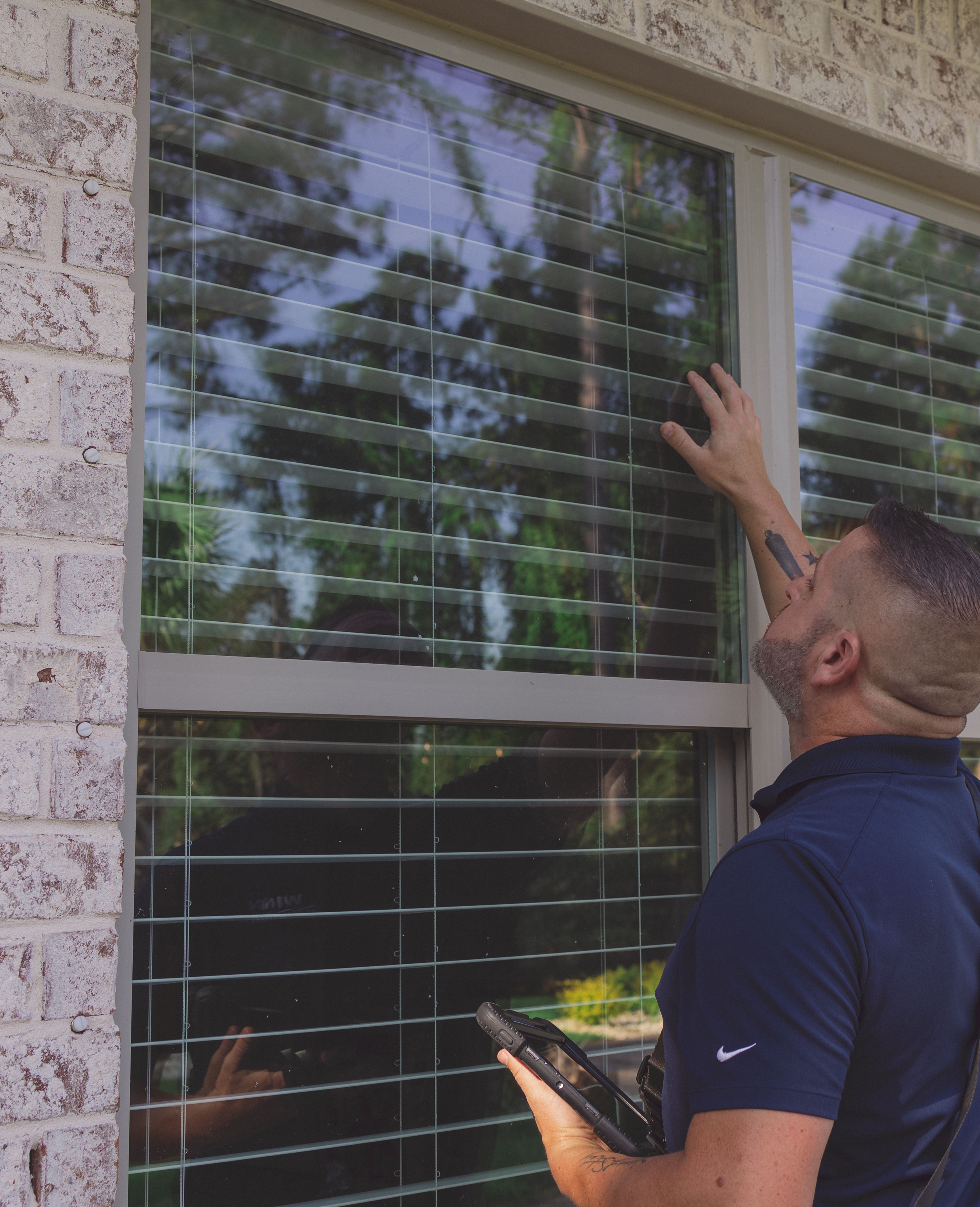 Home Inspector checking the window during Wind Mitigation Inspection