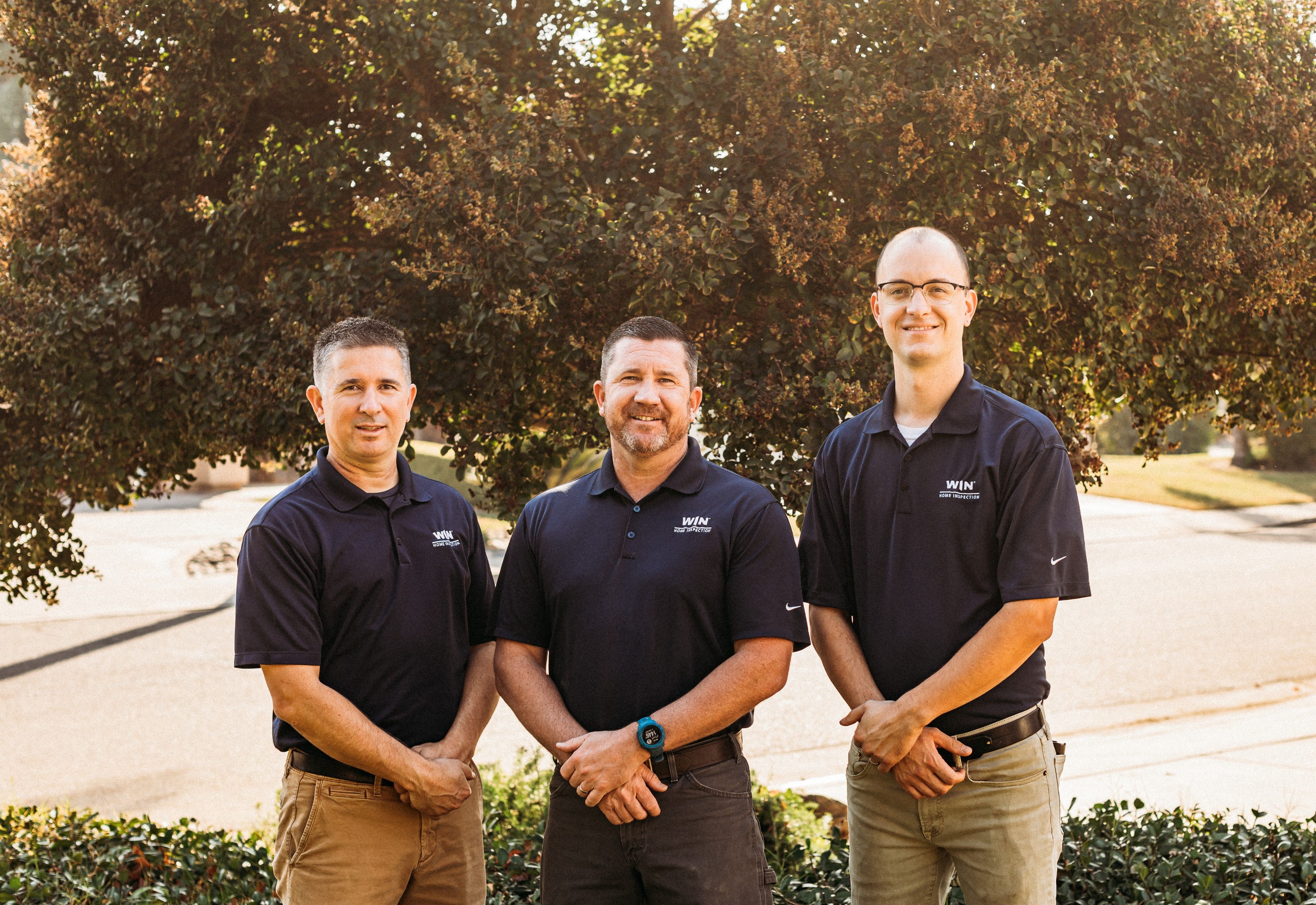 A team of three WIN Home Inspectors standing