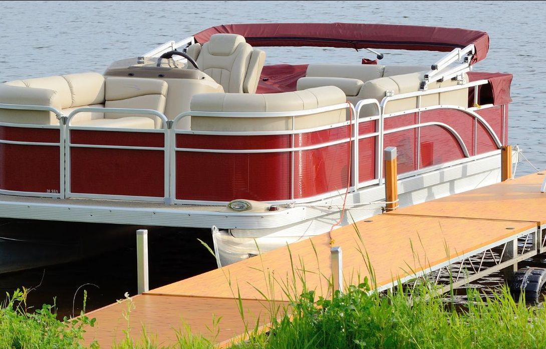 A red & white boat parked at the dock