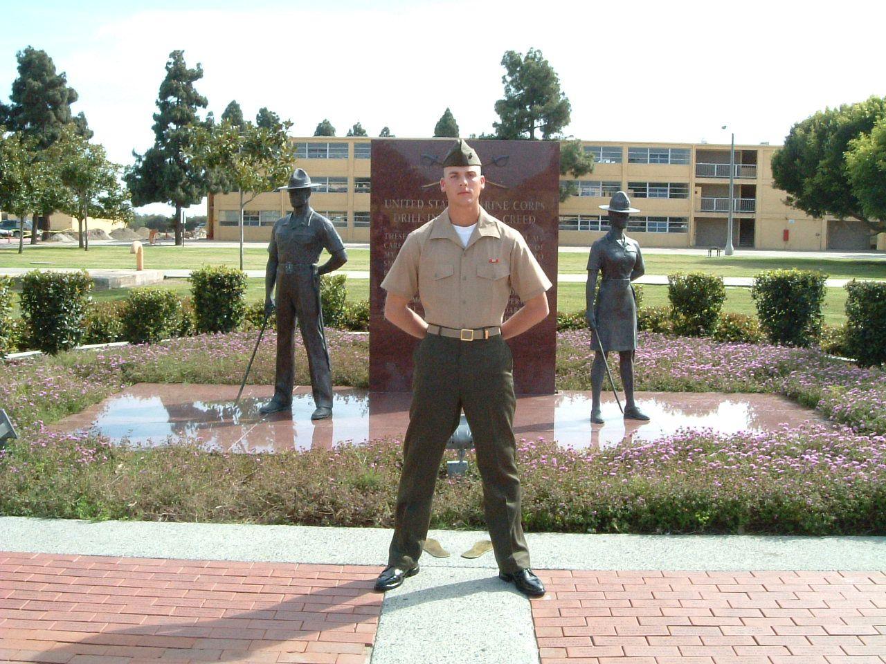 A group of soldiers in uniform holding a flag.