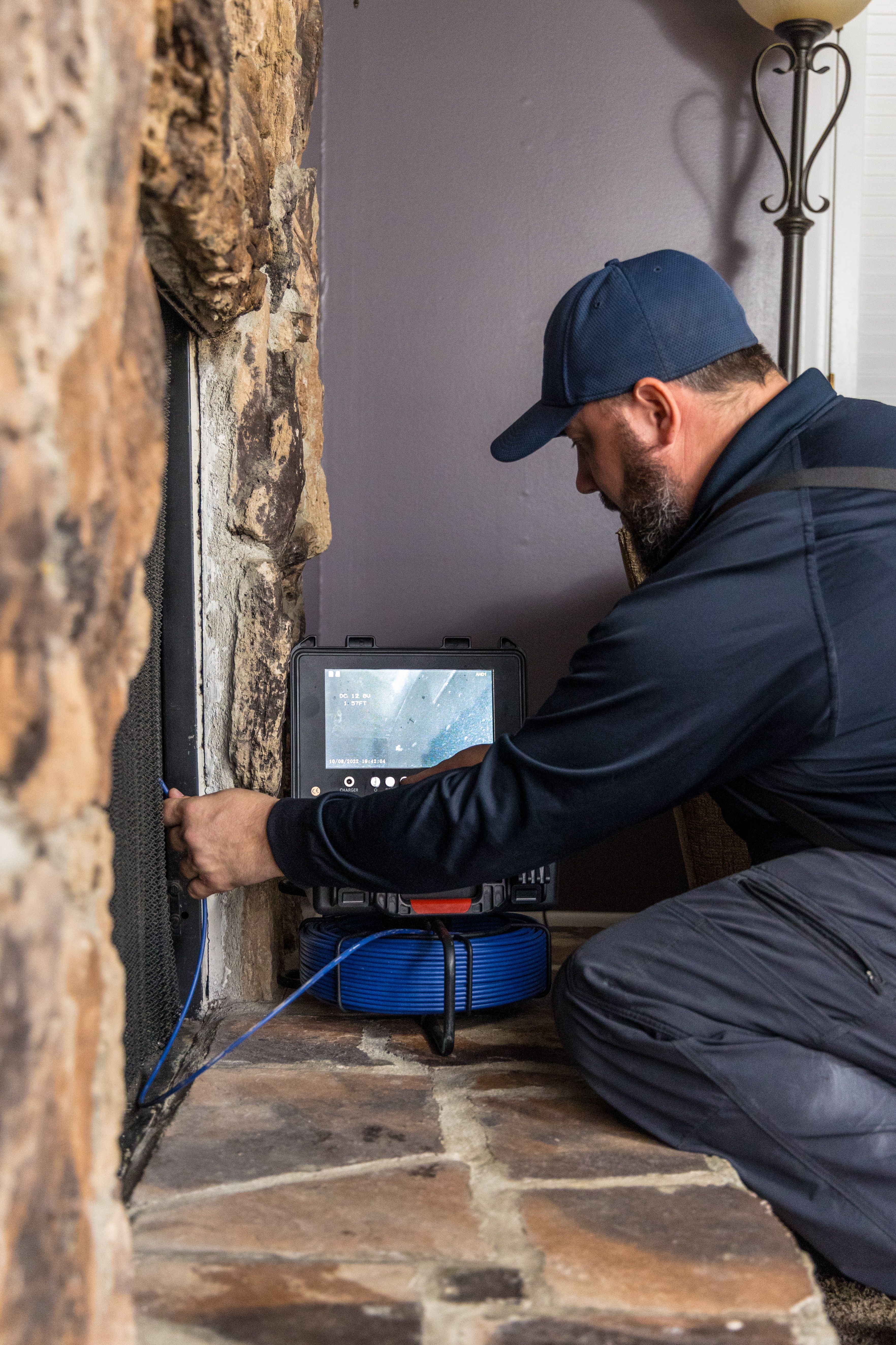 Home inspector checking the fireplace with the clients present