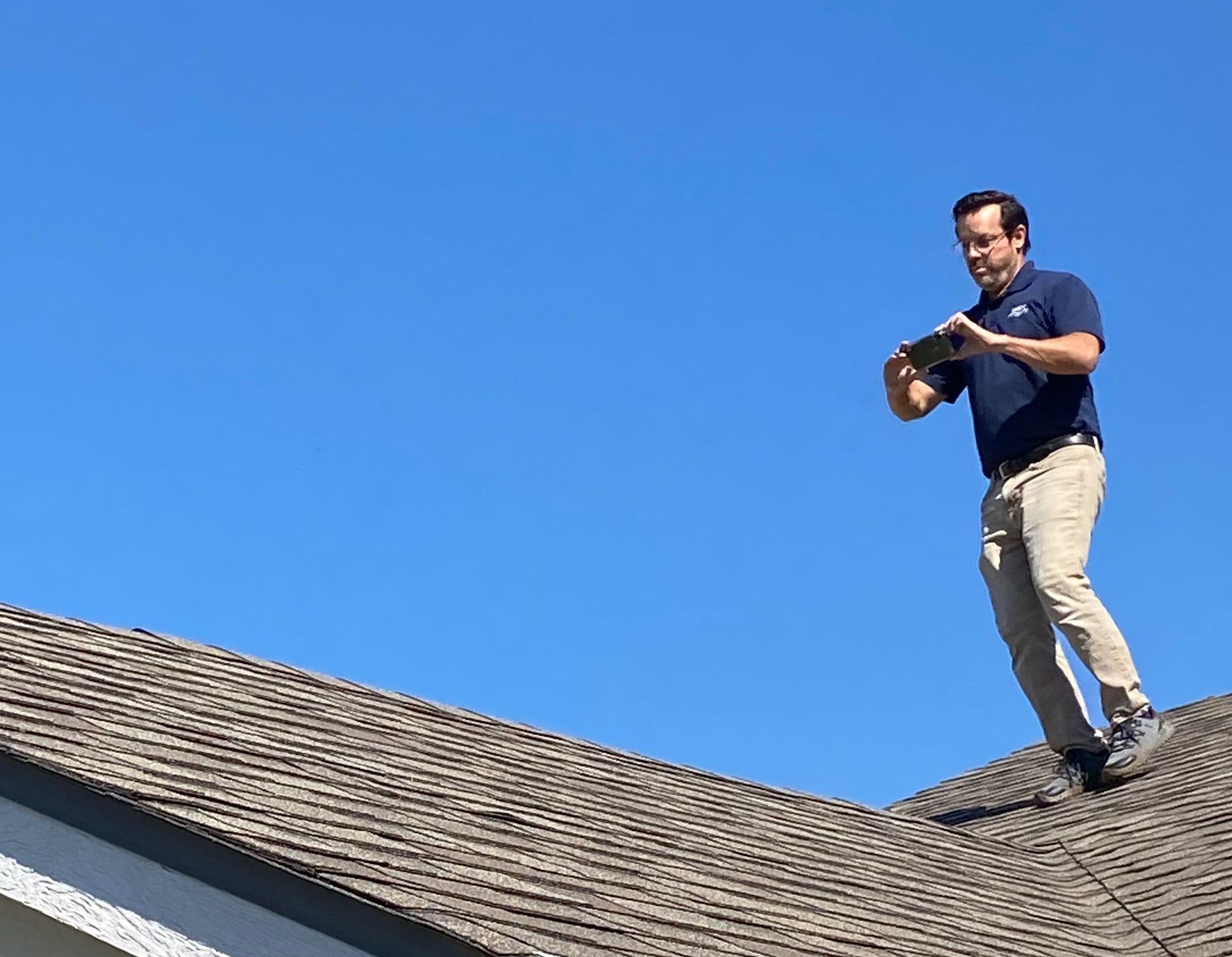 WIN Home Inspector performing a roof inspection