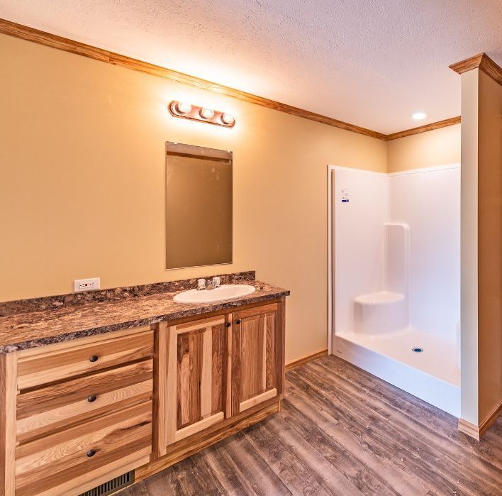 A bathroom with a sink and a shower