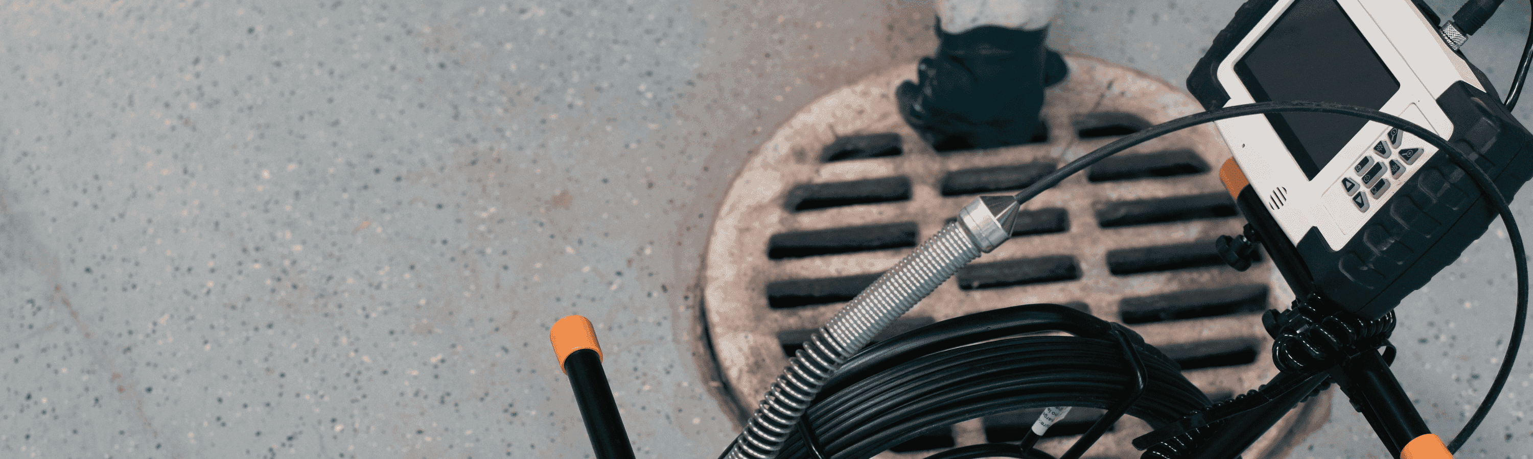 Sewer Inspection Camera. Man Removing Drainage Grill on Background.