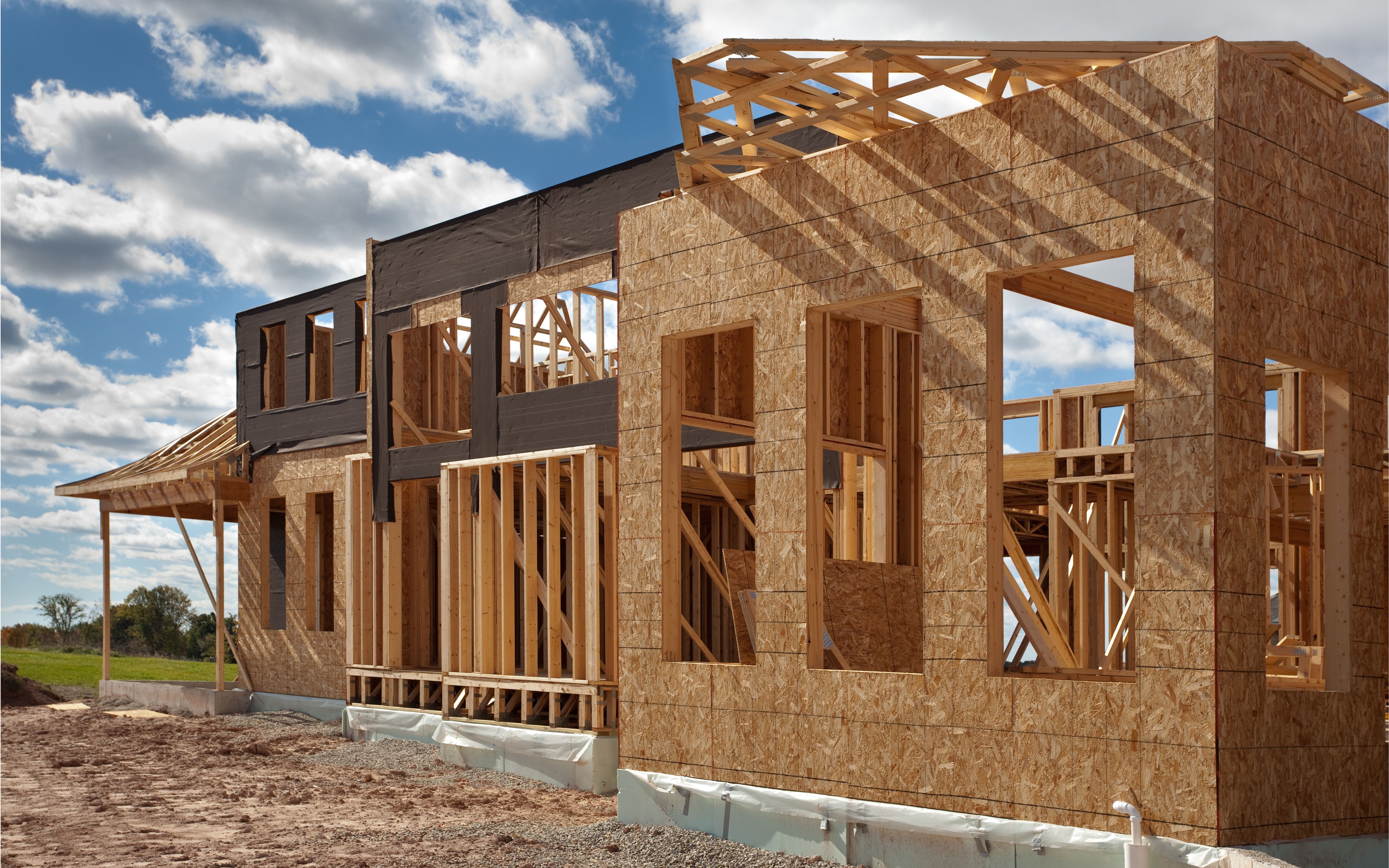 A house under construction with a blue sky