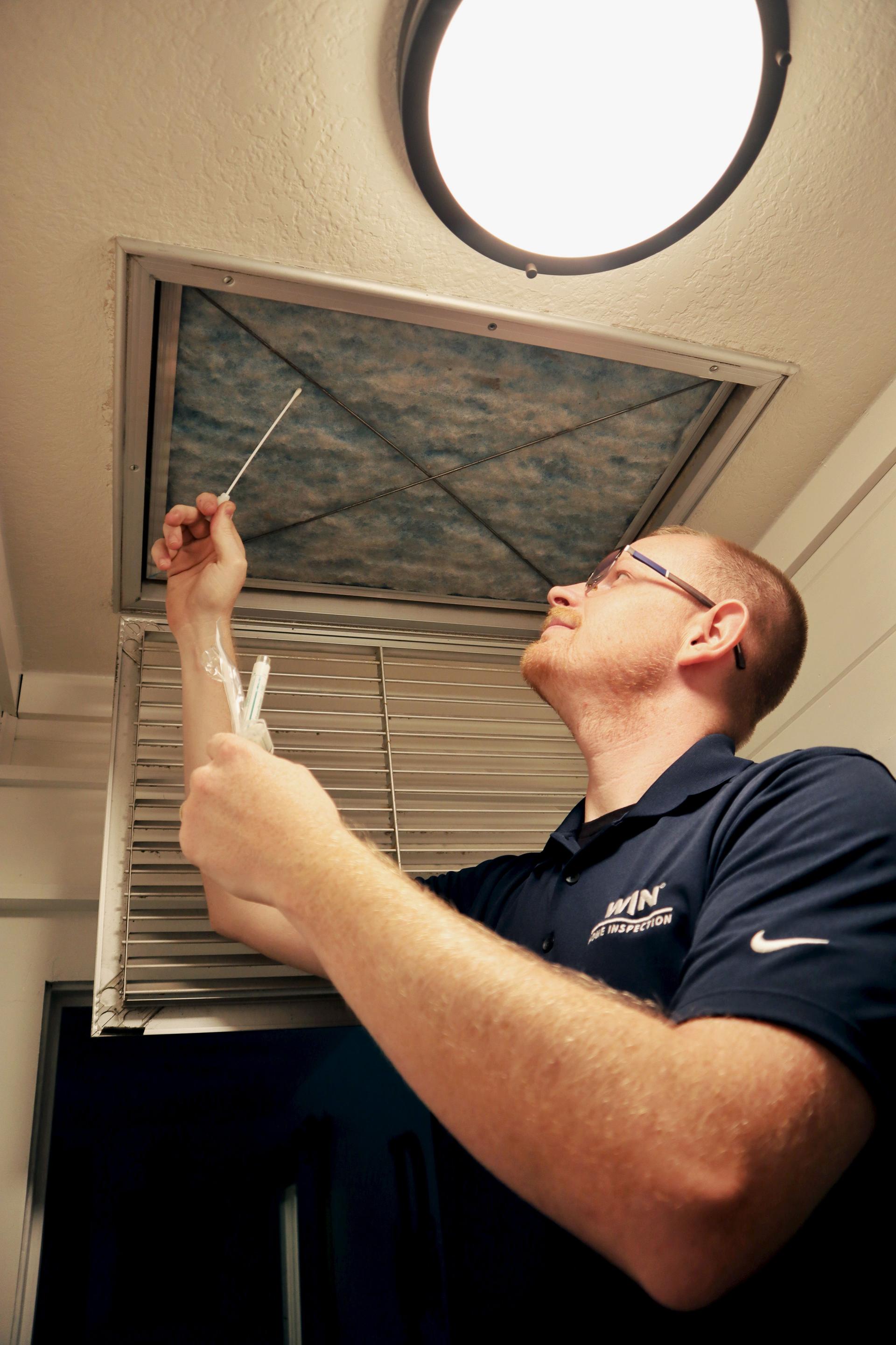 WIN Home Inspector checking the air quality of a home