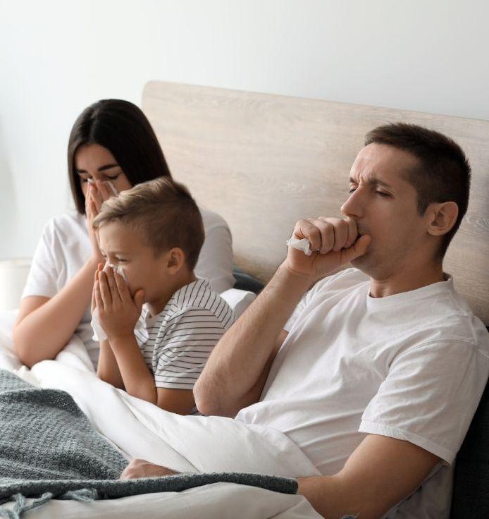 A family coughing due to bad air quality in the home