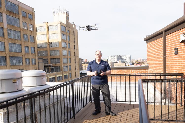 WIN Home Inspector controling a drone on a terrace balcony