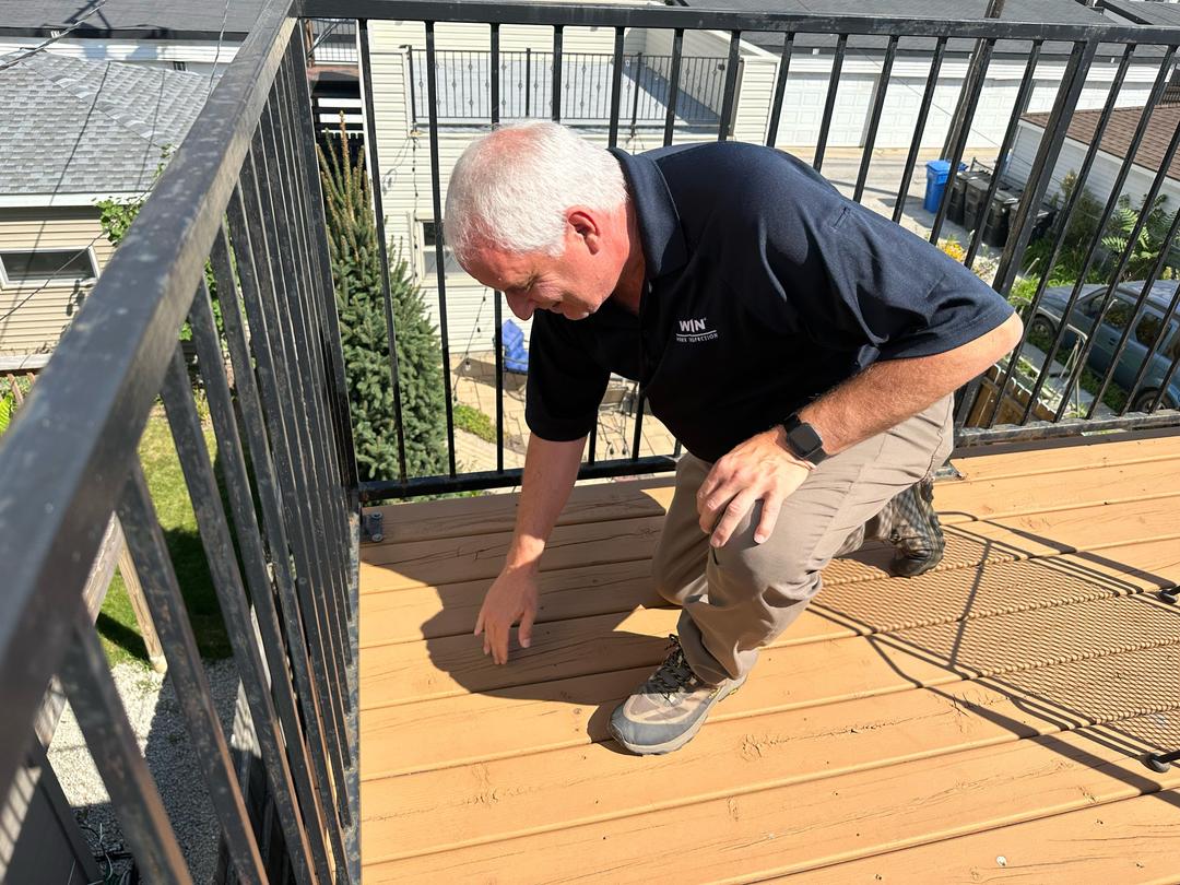 WIN Home Inspector checking a deck at a house