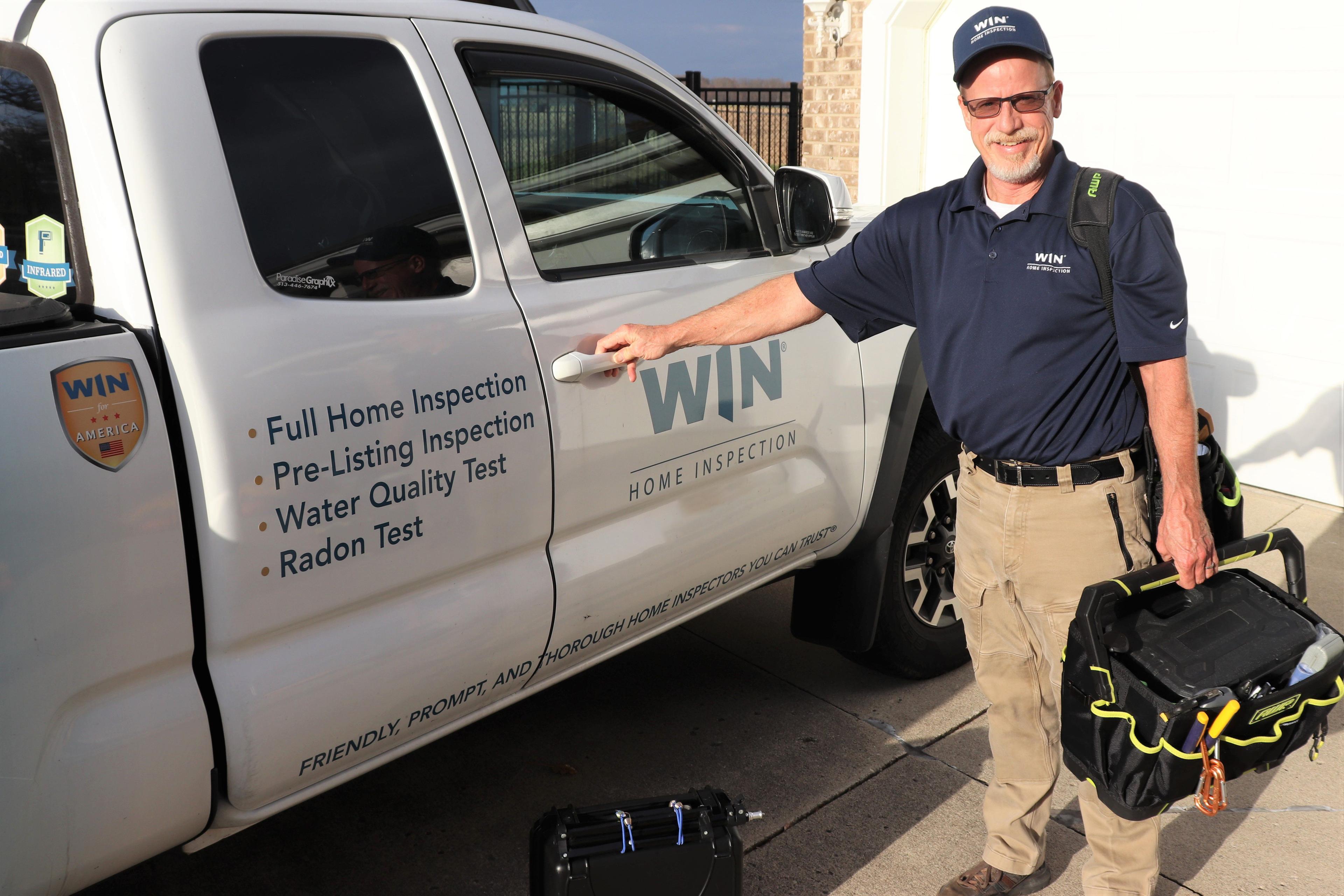 WIN Home Inspector with their branded WIN vehicle and inspection tolls.