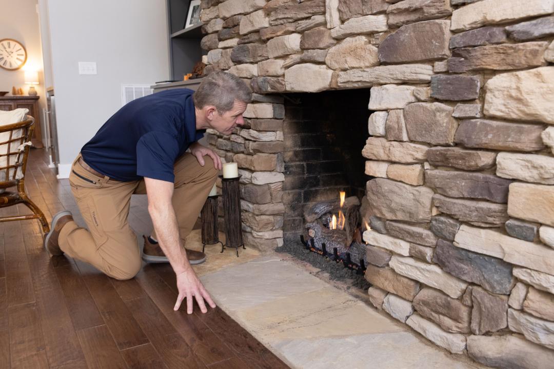 WIN Home Inspector checking the fireplace at a house