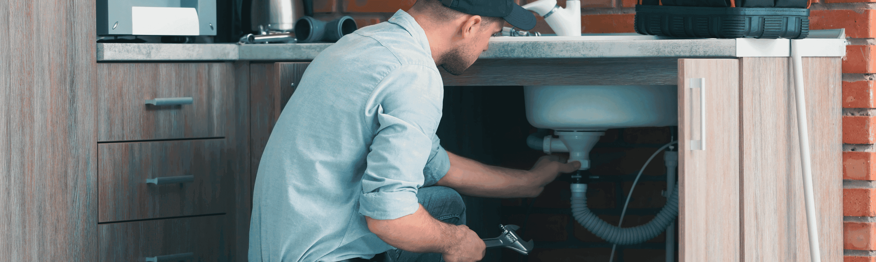 Professional Plumber Fixing Kitchen Sink
