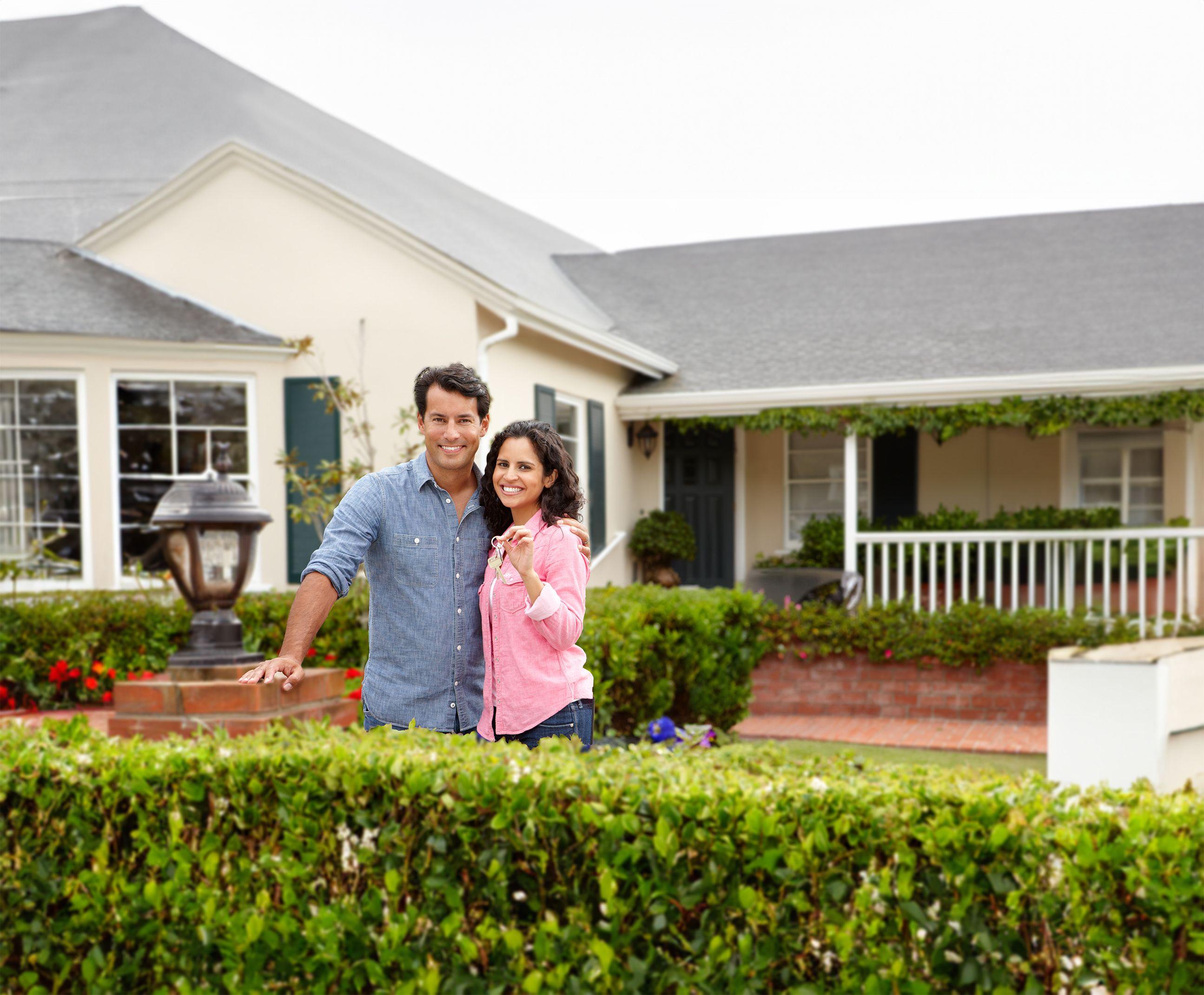 Home buying couple in front of a house.