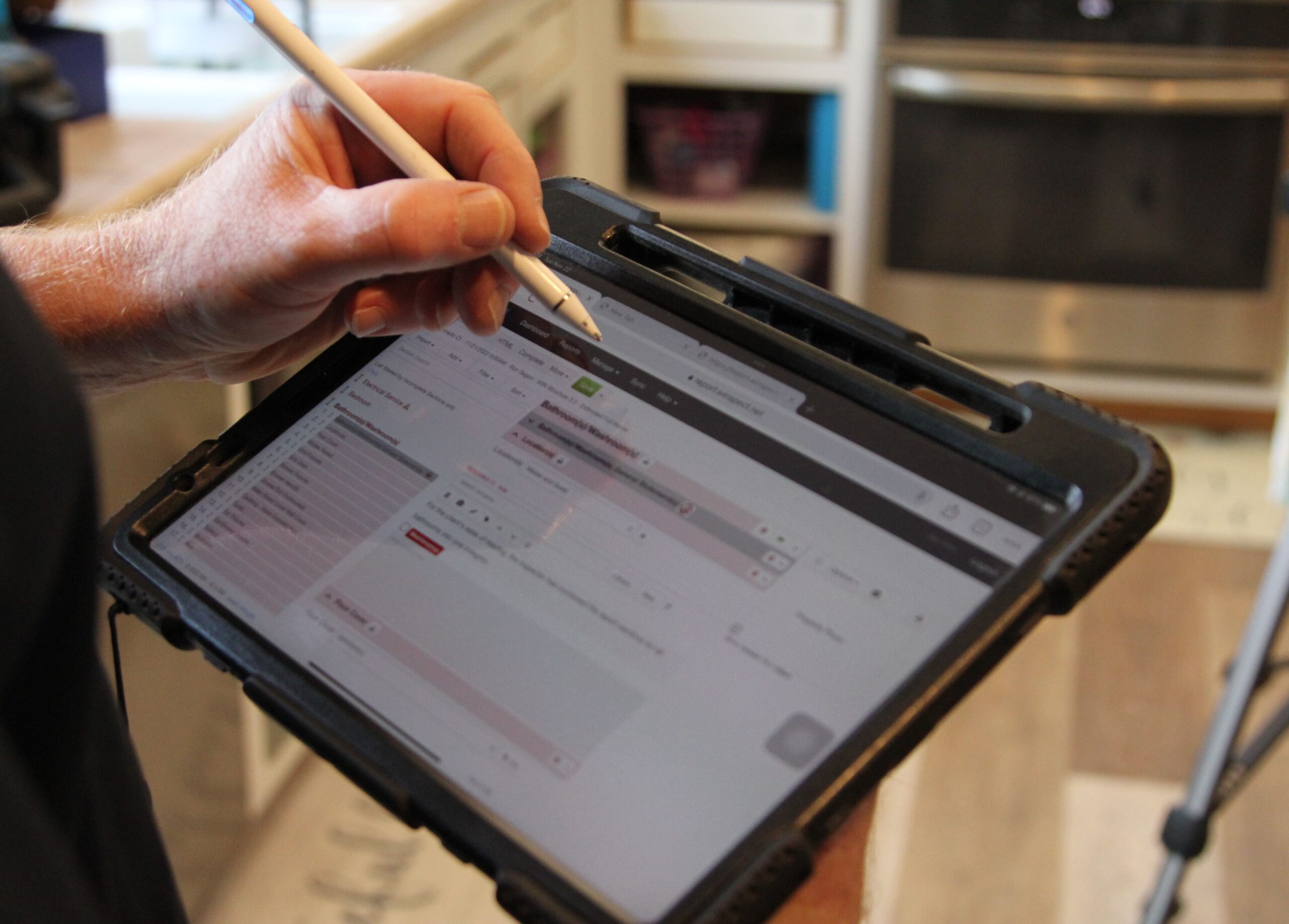 Home Inspector using a home inspection software on tablet