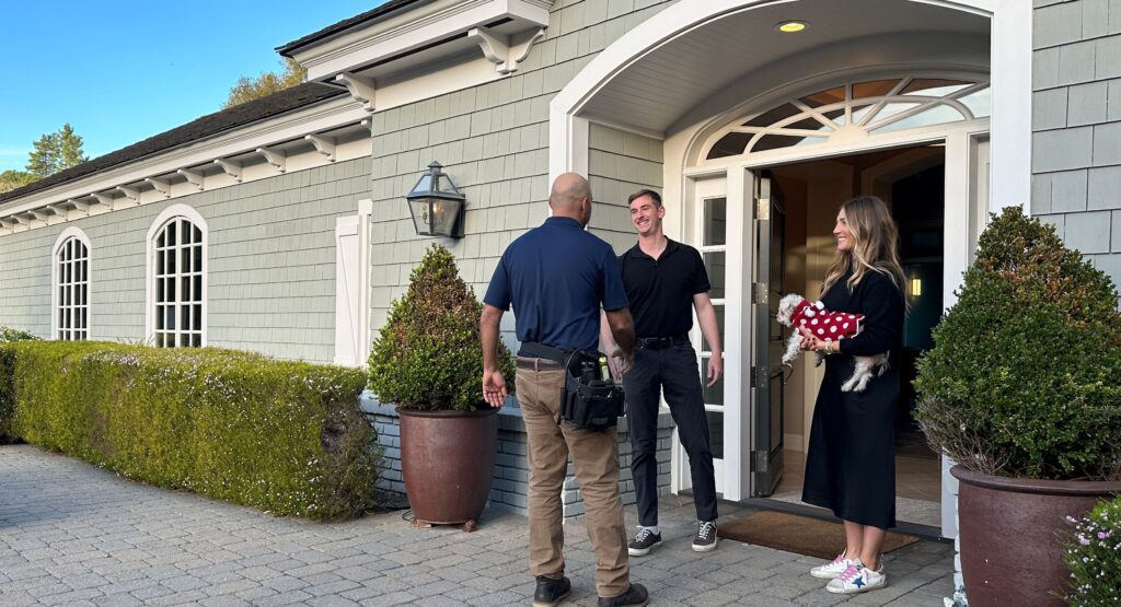 home inspection business owner with the clients at home entrance