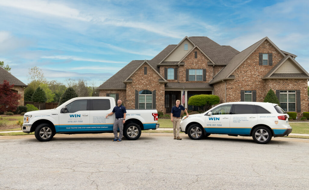 WIN Home Inspectors with their vehicles