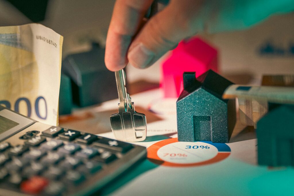 Housing investment financing prices. Hand holding key to new house door.