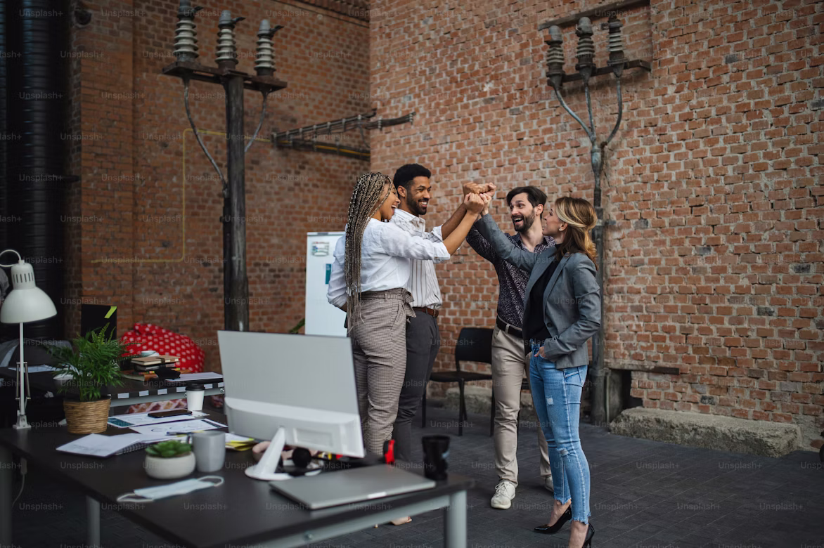 group of happy people in a working place