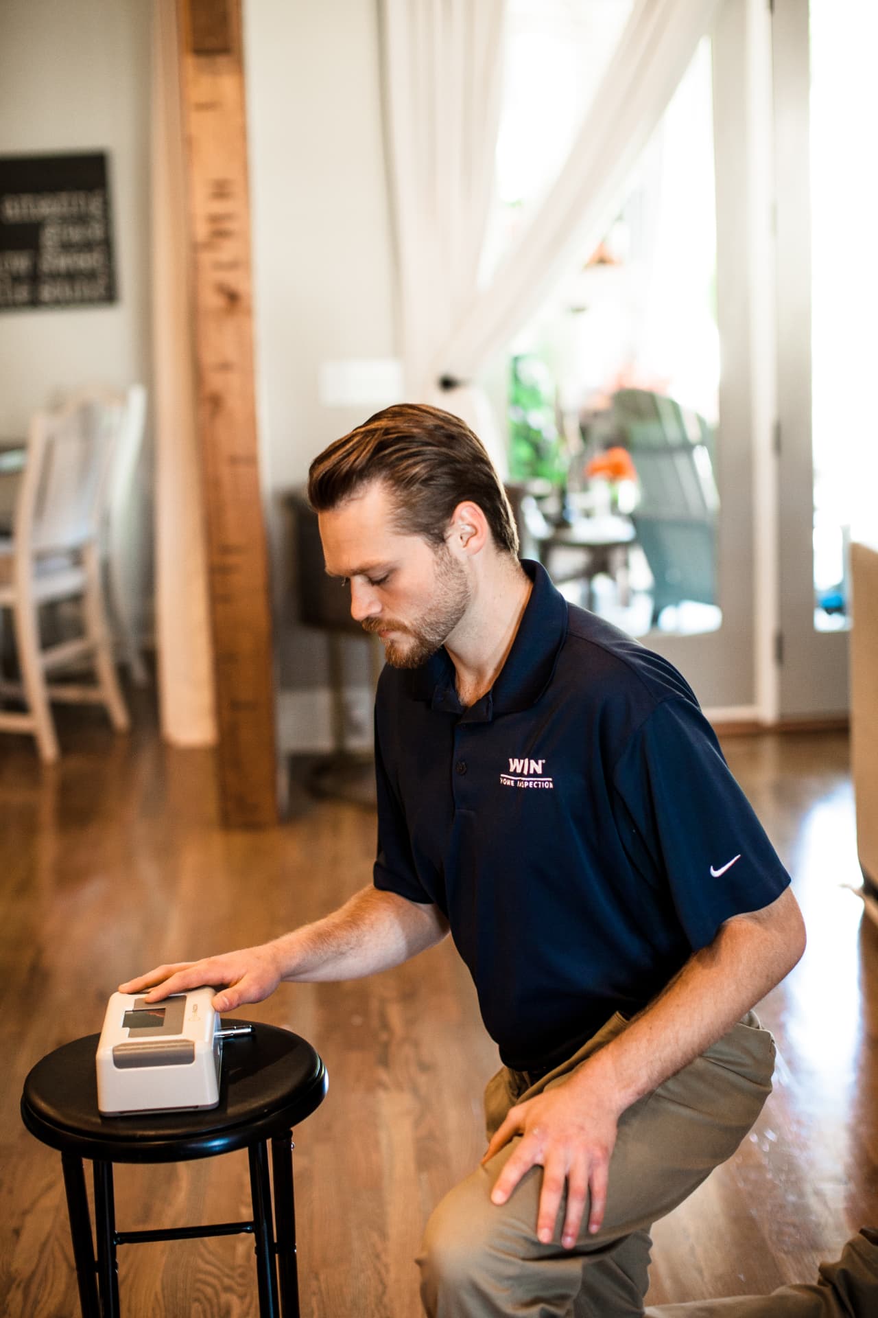 WIN home inspector using diagnostic equipment inside a Texas home